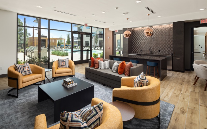 Resident lounge with view of the pool at The Grace Residences skyline view apartments in Atlanta.