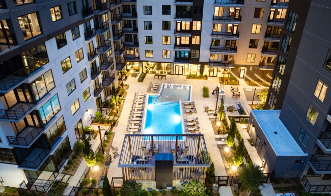 Pool with sundeck in Midtown, GA  Aerial drone shot of pool with sundeck and exterior building