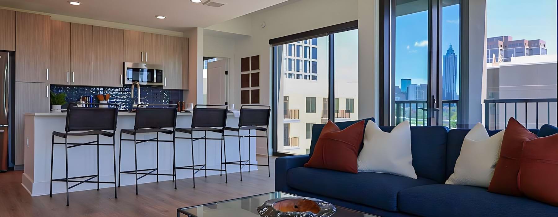 living room with kitchen and large windows