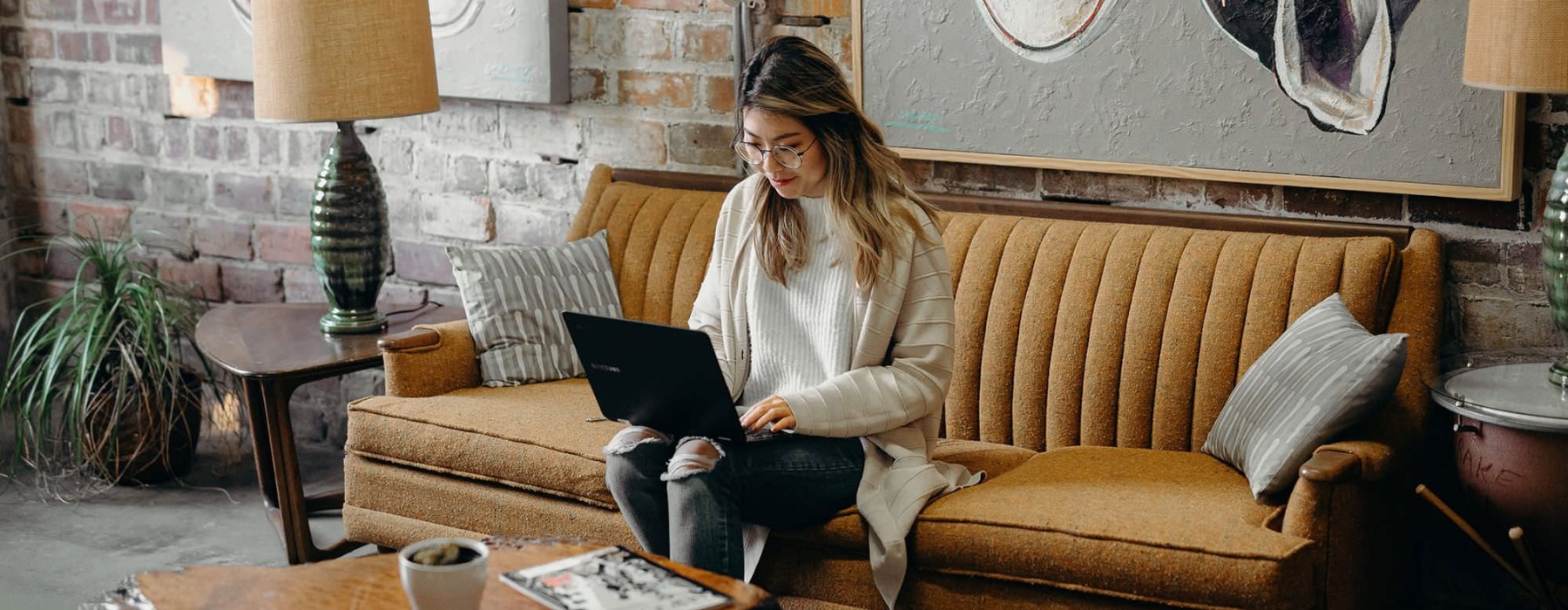 woman sitting on couch on a laptop